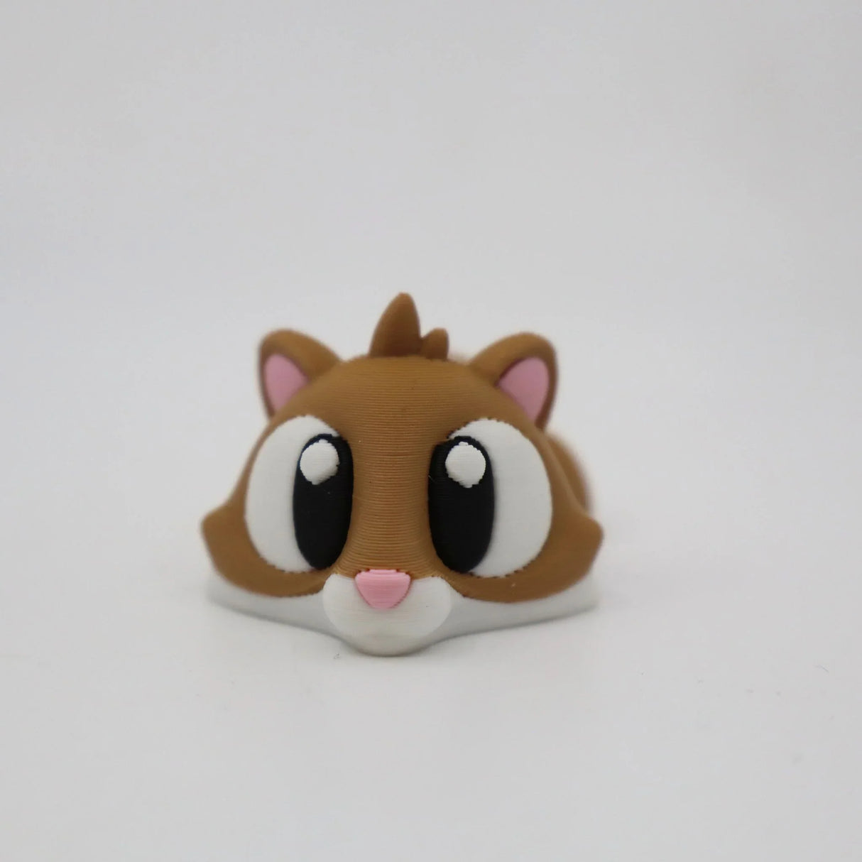 3D printed brown hamster sensory toy with large eyes and pink nose on white background