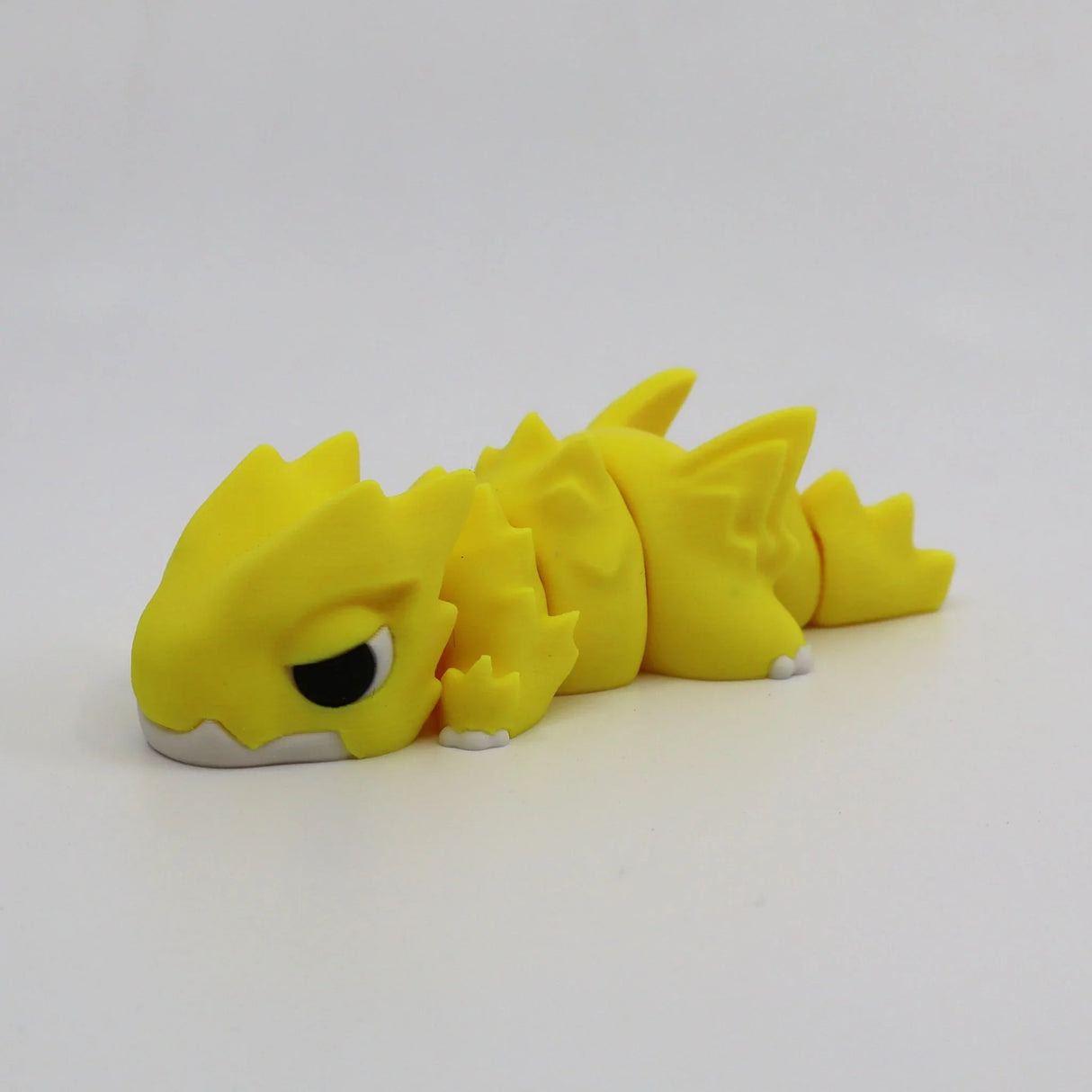 Yellow 3D printed flexi dragon fidget toy for sensory play and calming stimulation
