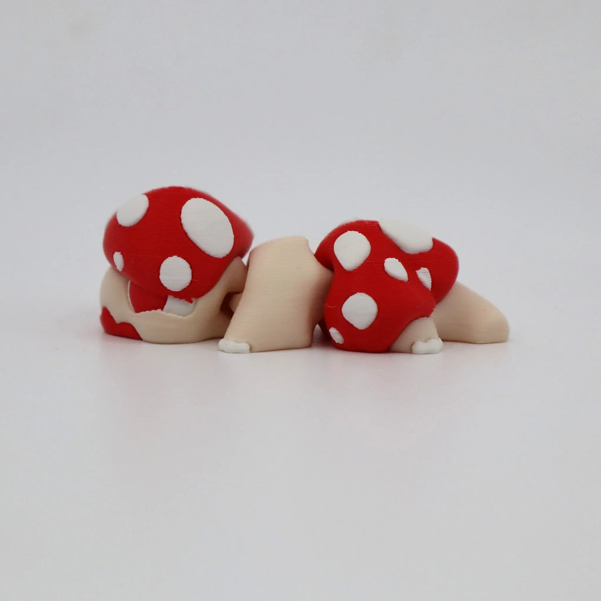 3D printed sensory toy turtle with red and white mushroom shell on white background
