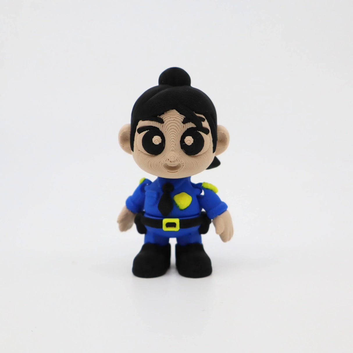 3D printed police officer fidget toy with blue uniform, yellow badge, and sensory texture for kids
