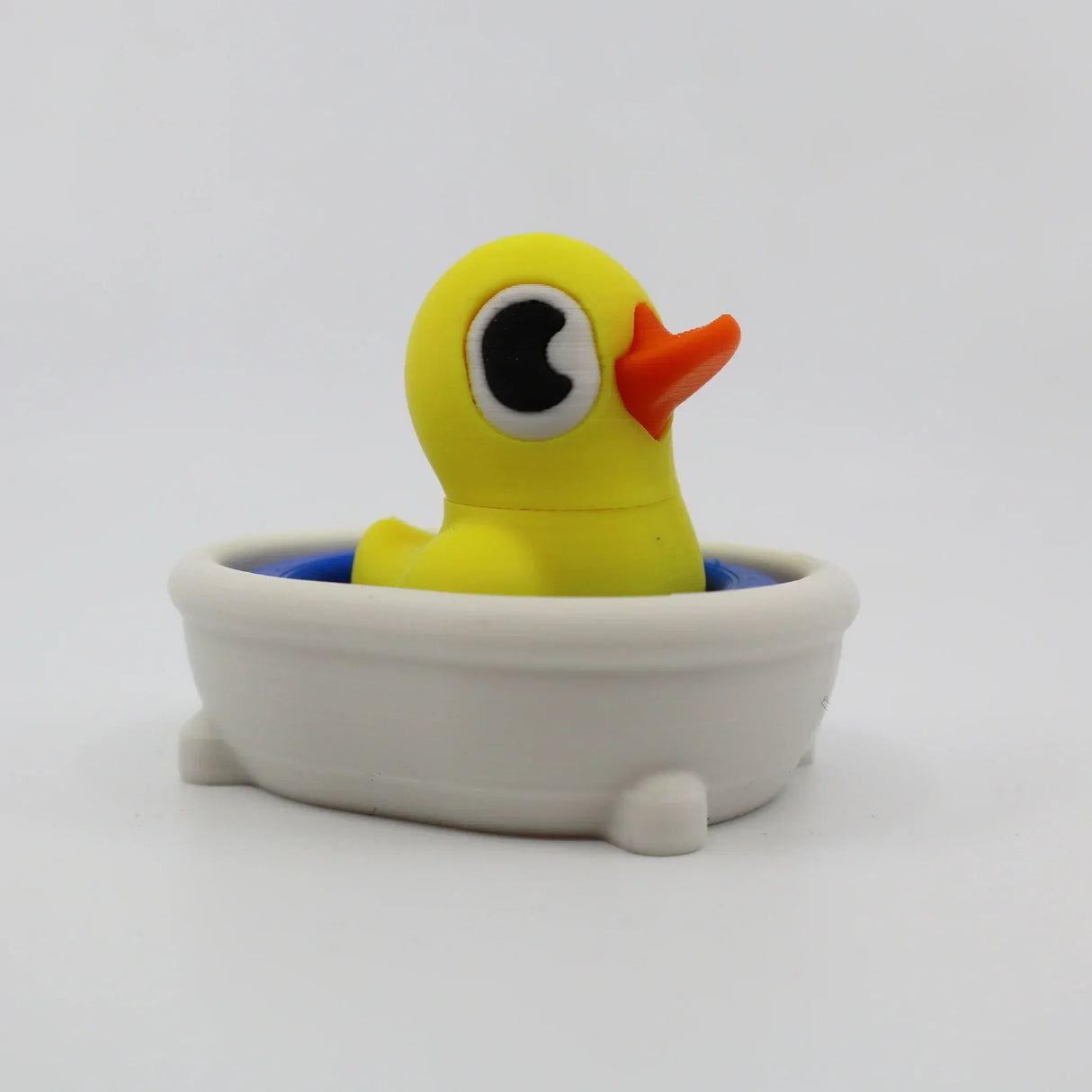 Yellow 3D printed duck in white bath toy for sensory play and fidgeting