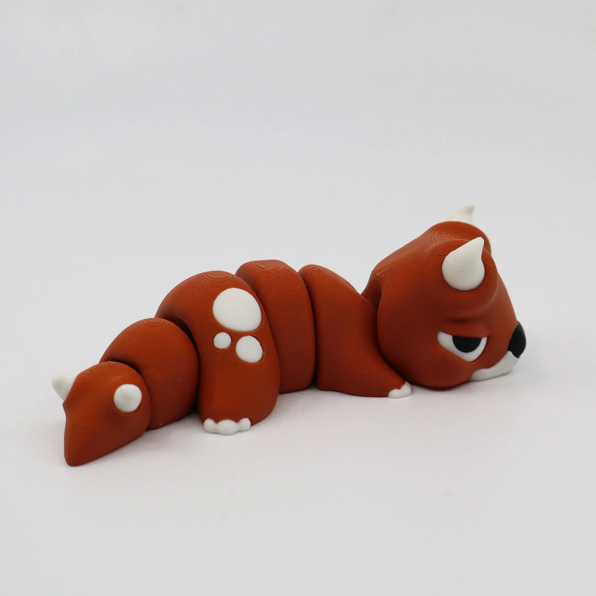 Brown 3D printed sensory fidget toy shaped like a flexible animal with white spots