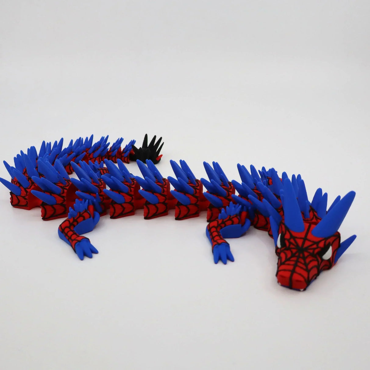 Red and blue 3D printed Spider-Man themed fidget dragon with articulated segments and sensory spikes