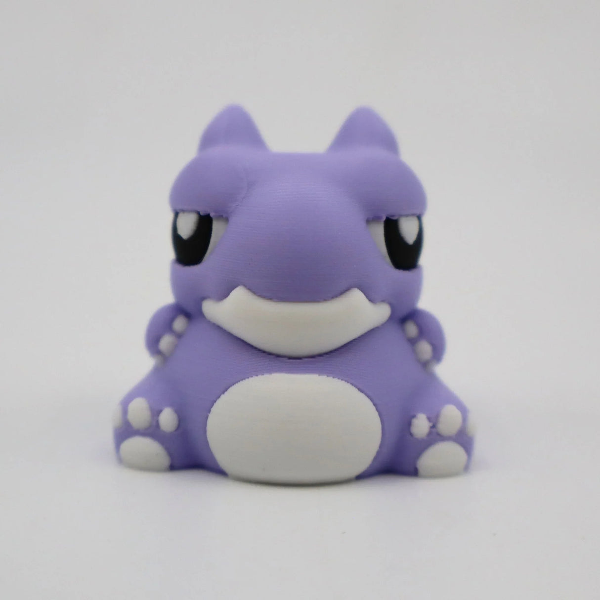Cute purple 3D printed warthog sensory toy with white details on a plain background