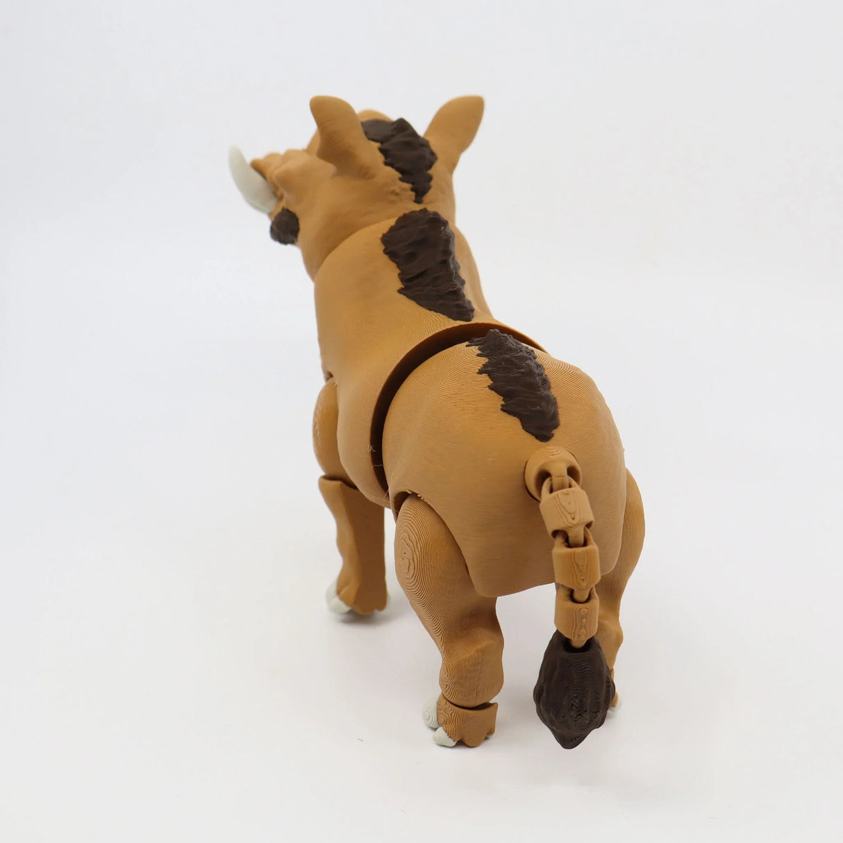 3D printed sensory warthog toy with articulated joints and textured brown body