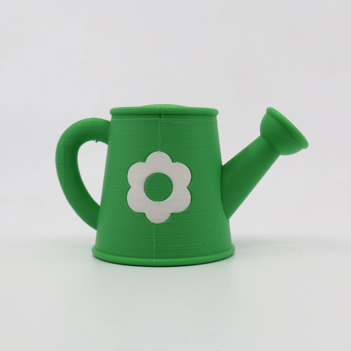 Green 3D printed sensory toy watering can with white flower, ideal for tactile play and learning
