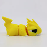 Yellow 3D printed sensory fidget toy shaped like a cute dragon, segmented and flexible.