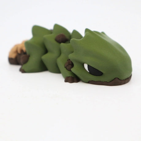 3D printed green sensory toy lizard with brown accents on white background