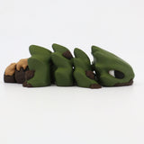 3D printed green and brown sensory fidget toy shaped like a segmented lizard on white background