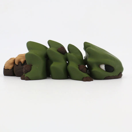3D printed green and brown sensory fidget toy shaped like a segmented lizard on white background