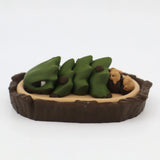 3D printed green dinosaur sensory toy with babies in a brown nest, educational fidget