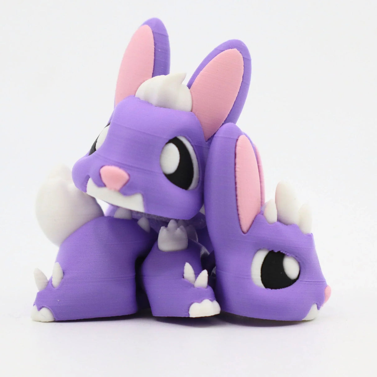 Purple 3D printed sensory bunny toy with white spikes and pink ears, cute animal design