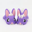 Two purple 3D printed sensory bunny toys with white spikes and pink details on a white background.