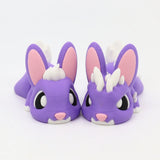 Two purple 3D printed sensory bunny toys with white spikes and pink details on a white background.