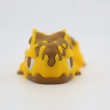 Yellow and brown 3D printed sensory toy resembling a cute animal, on white background.