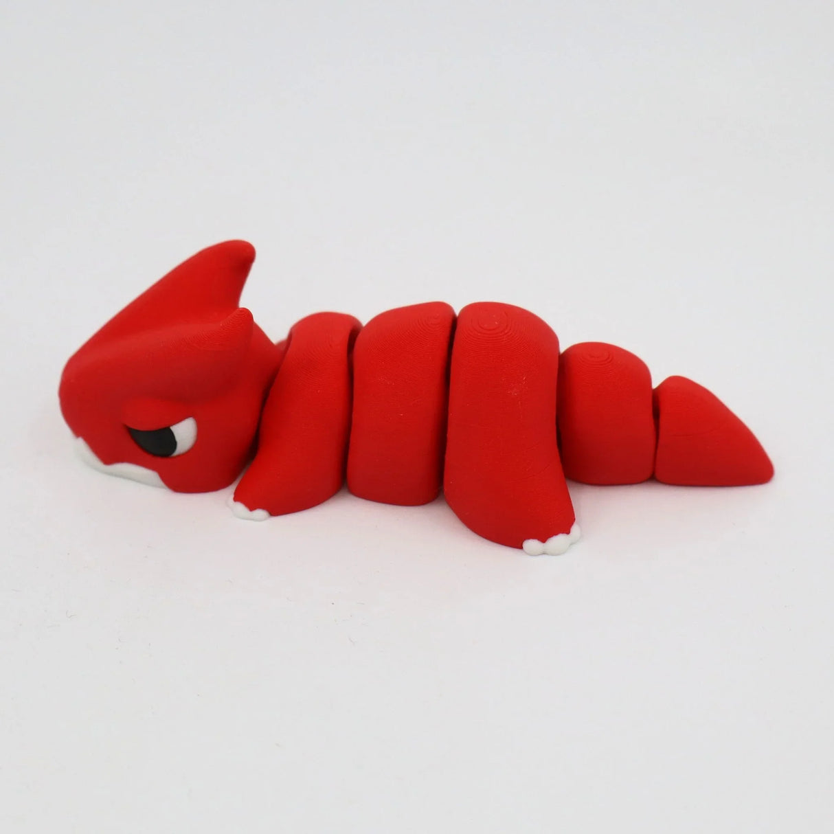 Red 3D printed flexi dinosaur sensory toy with segmented body on white background
