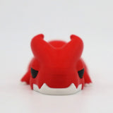 Red 3D printed dragon sensory toy with white fangs on a white background