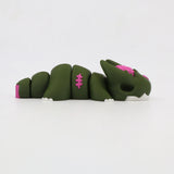 Green 3D printed sensory toy shaped like a segmented dragon with pink and white accents