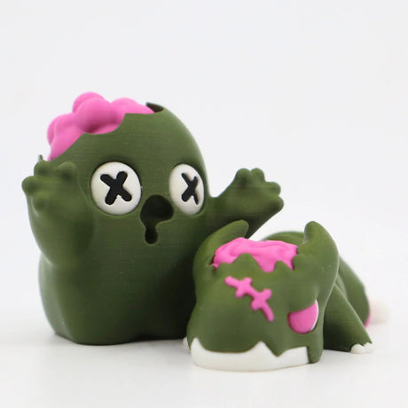 Green 3D printed sensory toy figures with pink accents, cute monster and animal design