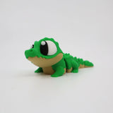 Green 3D printed alligator fidget toy with big eyes, sensory friendly for kids