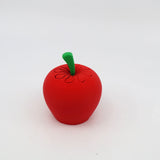 3D printed red apple sensory toy with green stem on white background