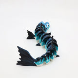 3D printed blue and black flexible barracuda sensory toy with jointed segments