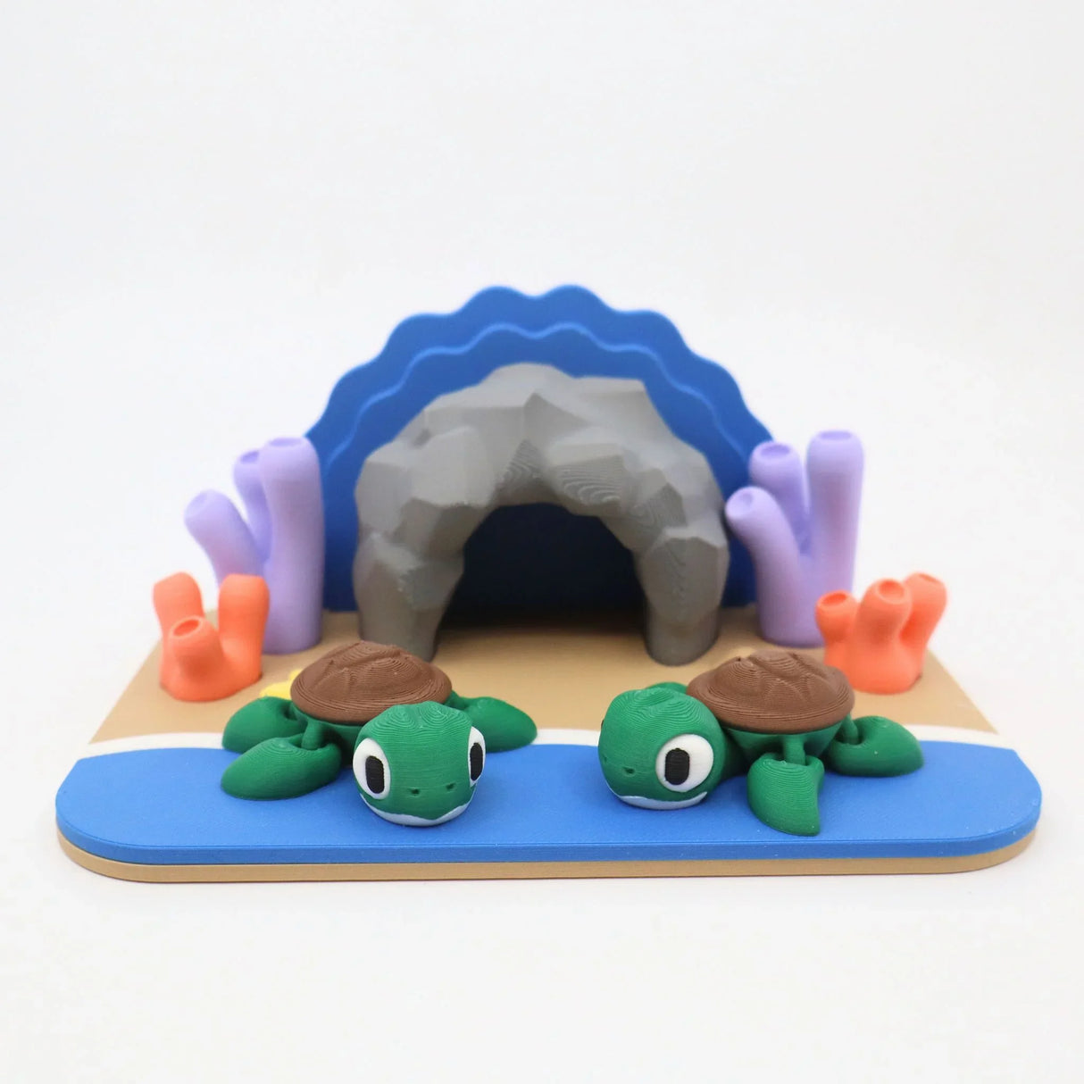 Colorful 3D printed sensory toy set with two green turtles, coral, and a cave scene