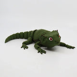 Green 3D printed bearded dragon sensory toy with flexible joints on white background