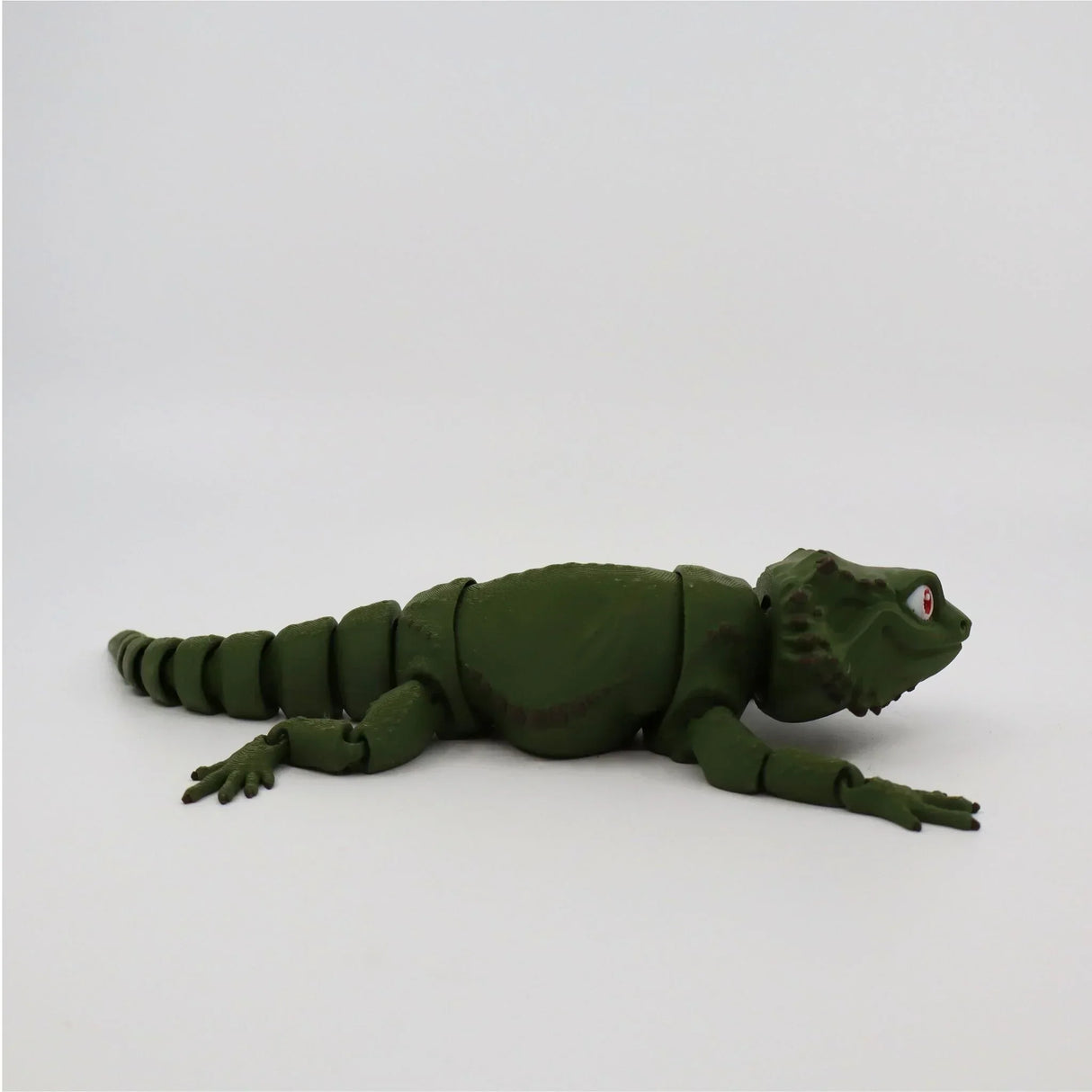 Green 3D printed fidget bearded dragon toy with jointed body on white background