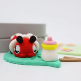 3D printed sensory toy ladybug with bottle on green base, colorful and playful design