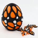 Orange and black 3D printed butterfly sensory toy with matching patterned egg case