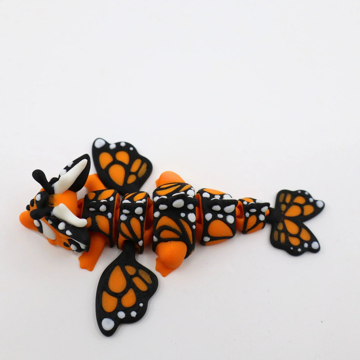 Orange and black 3D printed butterfly sensory fidget toy with segmented body