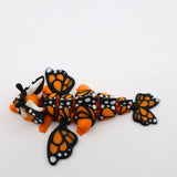 Orange and black 3D printed butterfly sensory fidget toy with segmented body