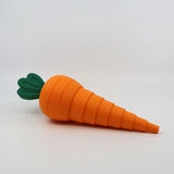 3D printed sensory carrot toy with orange segments and green top on white background