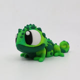Green 3D printed chameleon sensory toy with large eyes on white background