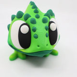 3D printed green chameleon sensory toy with large eyes and textured details