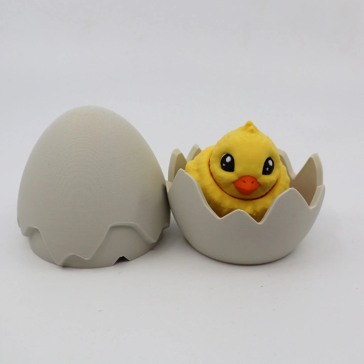 Cute yellow chick sensory toy in a 3D printed cracked egg shell, educational fidget toy