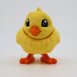 Cute 3D printed yellow chick sensory toy with orange beak and feet on white background.