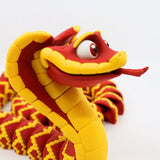 Red and yellow 3D printed snake sensory toy with playful features on a white background