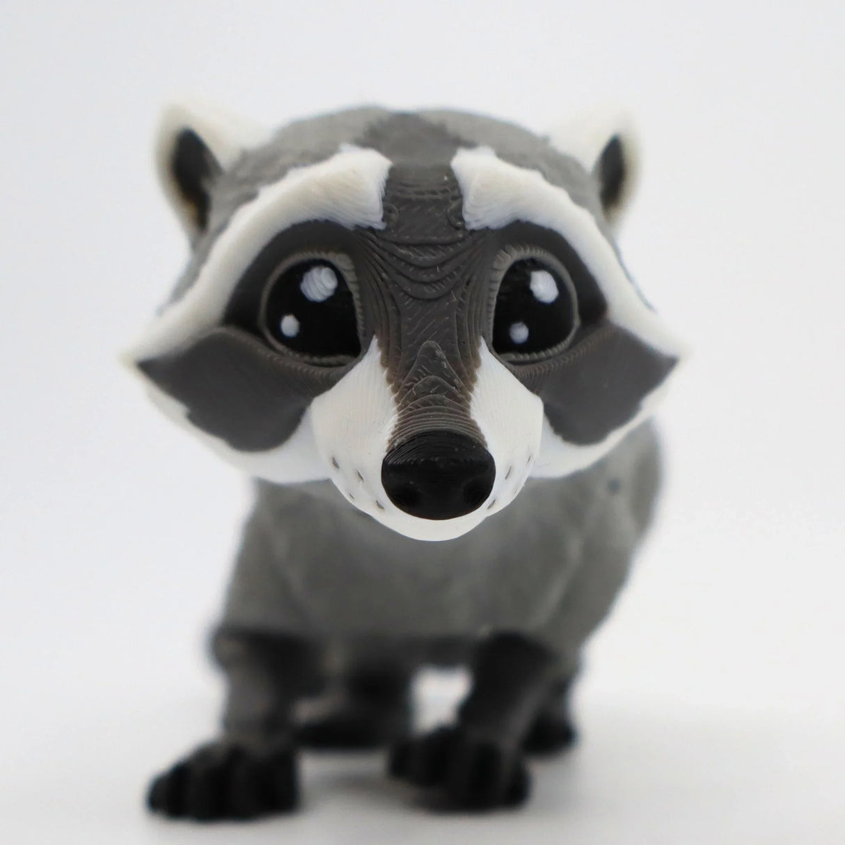 3D printed raccoon sensory toy with textured details on a white background