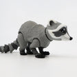3D printed raccoon sensory toy with movable joints on a white background