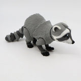 3D printed sensory raccoon toy with movable limbs on white background