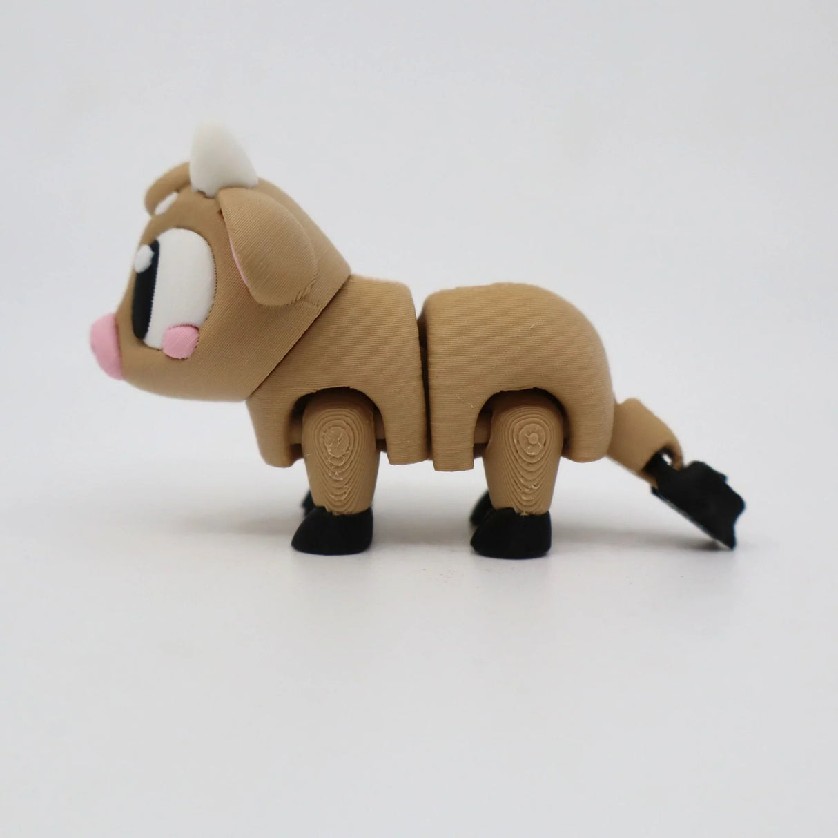 3D printed sensory toy cow with movable legs on white background