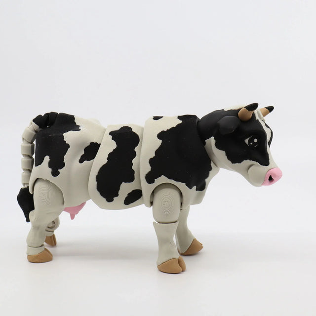 3D printed black and white cow sensory toy with movable joints on white background