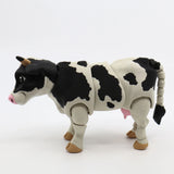 3D printed black and white cow sensory toy with movable limbs on white background