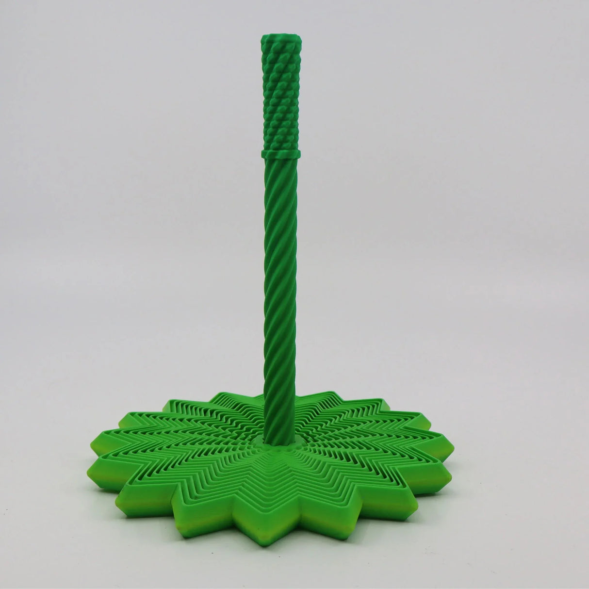 Green 3D printed sensory toy with textured stem and star-shaped base on white background