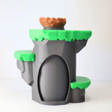 3D printed dinosaur cave toy with green platforms and brown nest, educational sensory play
