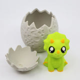 Cute green triceratops sensory toy with 3D printed dinosaur egg shell on white background