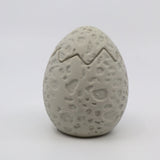 Textured 3D printed dinosaur egg sensory toy with crack detail, light gray color