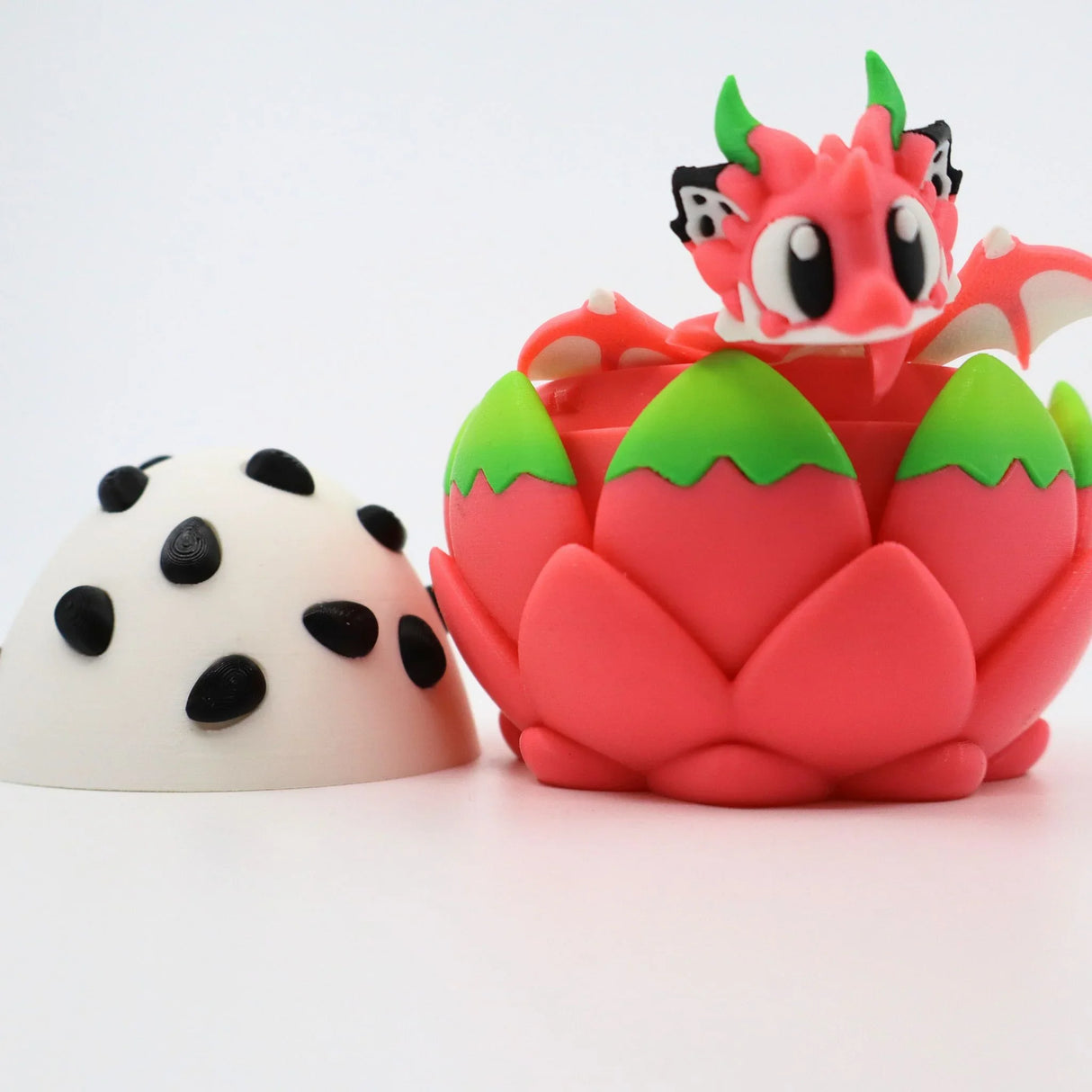 3D printed pink dragon fruit toy with adorable dragon figure hatching from spotted egg